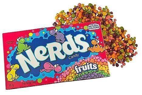 Krabička cukrovinek Nerds s motivem ovoce vedle rozptýlených drobných barevných cukrových kuliček.
